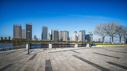 Modern City Skyline with Riverside Promenade