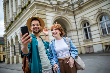 Young couple, on a vacation, exploring the new city and using their phone as gps to help them not get lost.