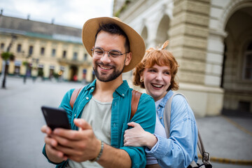 Young couple, on a vacation, exploring the new city and using their phone as gps to help them not get lost.