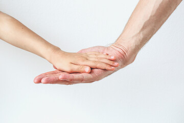 hand of child and father on white background