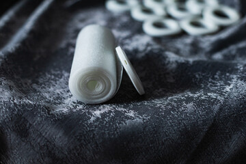 white eyelets and grommet tape on a curtain, top view, installing eyelets in curtain
