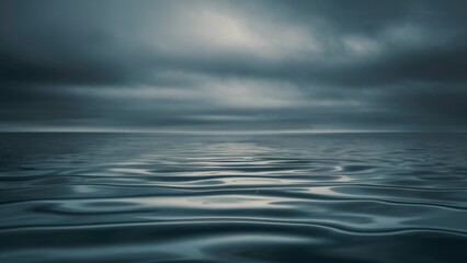Obraz premium An endless expanse of calm but dark ocean water merging with a gloomy, overcast sky, with subtle ripples disturbing the otherwise still surface, symbolizing inner turmoil.