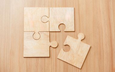 solve, strategy, problem, game, answer, cooperation, difficulty, group, jigsaw, join. A wooden puzzle piece is missing. as the missing piece is the final piece needed to complete.