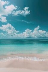 Fototapeta premium Calm ocean waves, sandy beach with clouds reflecting in water.
