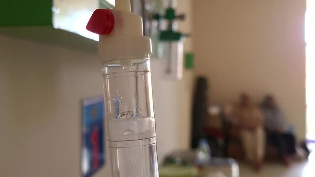 iv drip drops into the patient's room Closeup Saline solution or NSS fluid from IV bag NSS iv dripping tube infusion pumping in hospital chemotherapy