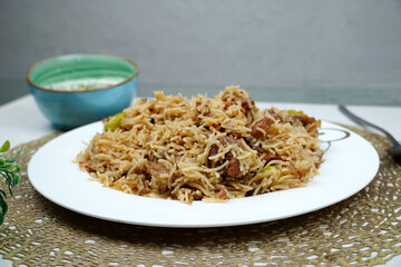 Beef pulao in white plate. Beef Yakhni Pulao. plate of rice