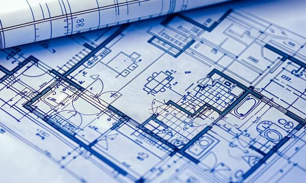 An architectural blueprint featuring detailed floor plans for a building, highlighted in blue with various room layouts and design elements visible