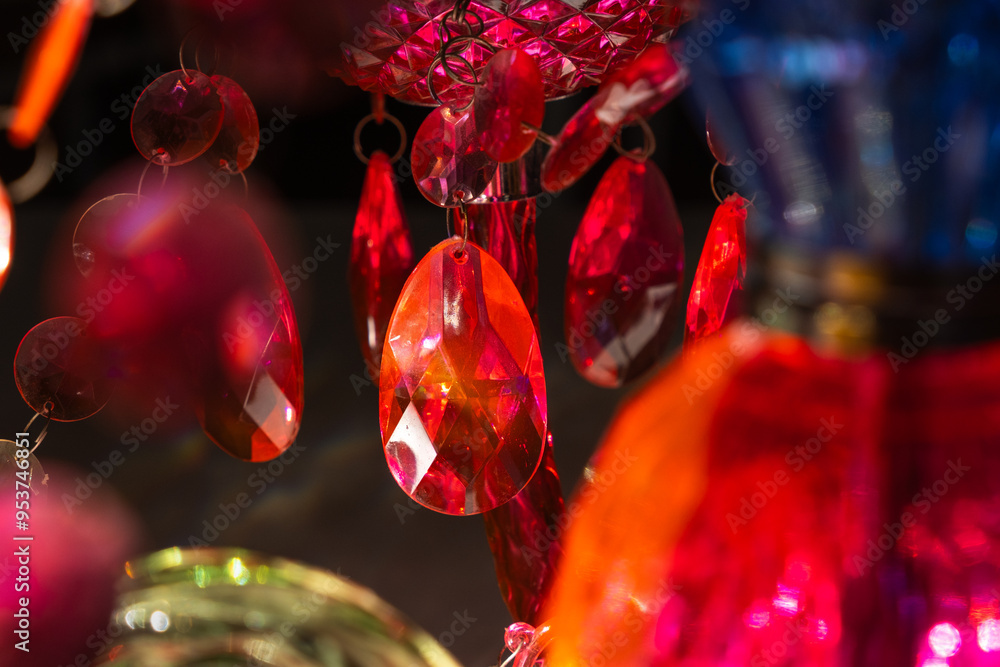 Wall mural detail of a brightly red and pink colored retro style chandelier in the interior of a house. it is m