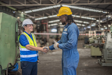 Industrial Workers Shaking Hands in Factory