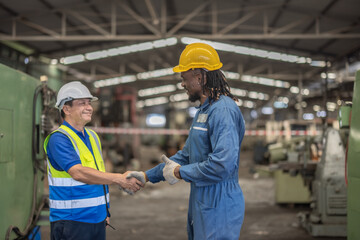 Industrial Workers Shaking Hands in Factory