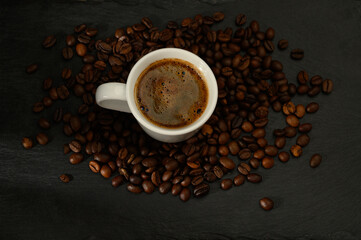 Close-up of coffee cup with beans on table
