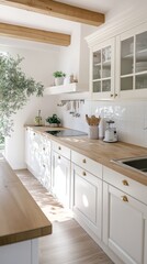 A kitchen with white cabinets and a wooden countertop 