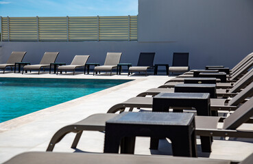 Fototapeta premium swimming pool and sun loungers close up