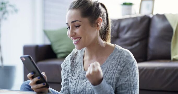 Winner, surprise and woman on smartphone for online deal, promotion or sale in home living room for e commerce, social media and newsletter. Winning, yes and wow girl using phone for app competition