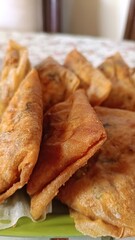 A plate of fried food with a green background