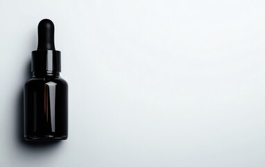 Naklejka premium Elegant black dropper bottle on a minimalist background, perfect for skincare or wellness product imagery.