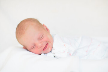 Little baby on white bed