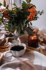 Experience a Cozy Morning Setup Featuring Coffee, a Warm Candle, and Beautiful Greenery