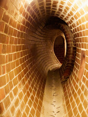 Old brick tunnel with light in the end of the tunnel. Interior of old tunnel. 