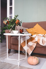 Create a Cozy Indoor Autumn Decor Featuring Charming Pumpkins and Beautiful Flowers