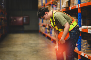 Work accidents concept. Warehouse worker has knee pain from working hard in warehouse. Safety at work concept.