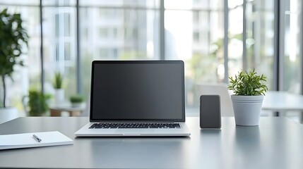Fototapeta premium Sleek Modern Office Desk with Laptop,Smartphone,and Notepad for Professional Work