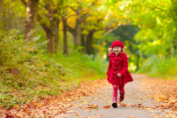 Little girl in autumn park