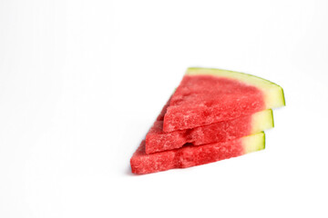 closeup of some pieces of refreshing watermelon on a white background