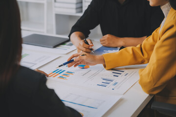 Financial analysts analyze business financial reports on a digital tablet planning investment...