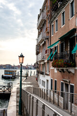 Serene waterfront in Venice with historic buildings and a peaceful atmosphere during twilight hours © evalco