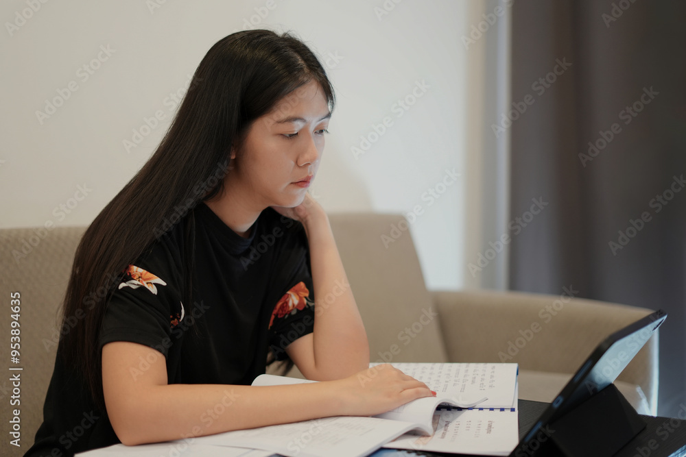 Wall mural female young thai language teacher, college tutor coach looking at webcam and talking with students 