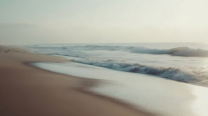 Gentle waves lapping at the shore under a hazy sky, creating a serene atmosphere perfect for relaxation