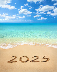 2025 written on sandy beach