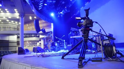 Professional camcorder recording live music concert on stage