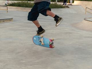 Skateboarder doing a flip trick on a skatepark.