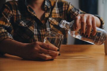 healthy beautiful young woman holding glass of water