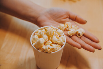 A woman holding a bowl of popcorn