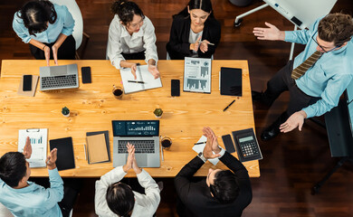 Obraz premium Panorama top view diverse group of business analyst team analyzing financial data report paper on meeting table. Chart and graph dashboard by business intelligence analysis. Meticulous