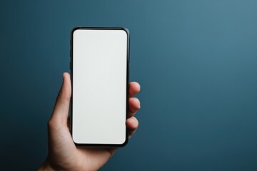 Hand holding smartphone with blank screen on blue background
