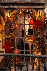 Background for design. New Year's decorations, toys and garlands on the windows in fabulous scenery. Houses for children in a public place.