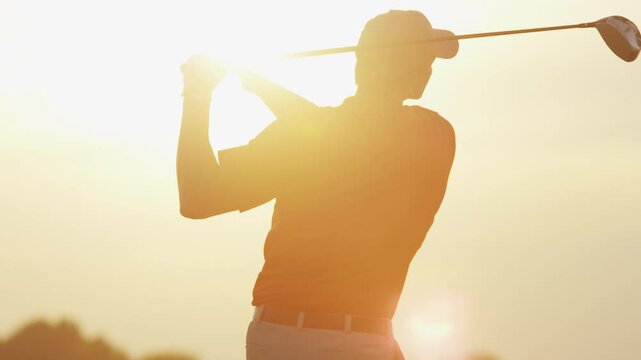 Golfer Driving Off Sunset Golf Resort Fairway