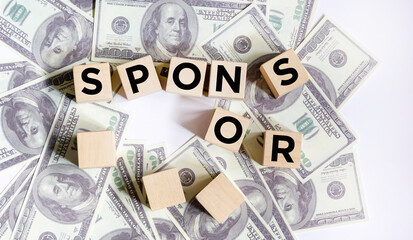 wooden blocks with SPONSOR written on dollar bills