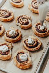 cinnamon rolls icing on tray