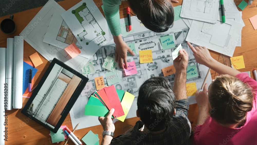 Poster Top view of engineer working together to design building construction while standing at meeting table with blueprint and notes. Top view of interior designer choosing color from palettes. Symposium.