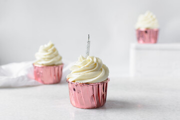  Pink cupcakes with tall buttercream swirl, cupcakes in pink foil liners with vanilla buttercream