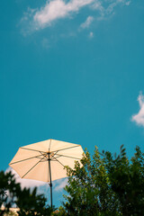beach umbrella on blue sky background