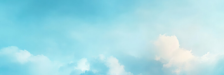 Soft white clouds drift across a light blue sky