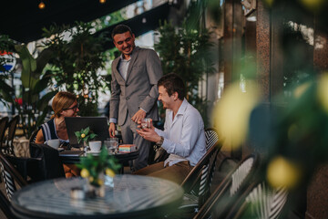Group of businesspeople enjoying a relaxed outdoor meeting at a cafe, engaging in conversation and sharing ideas with coffee and laptops.