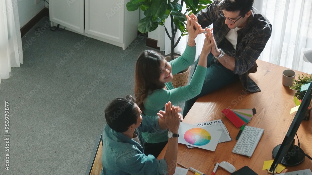 Poster top view of professional business team hands looking at color palette at table while giving high fiv