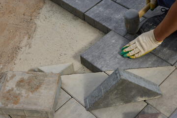 The Comprehensive Process for Installing Paving Stones Utilizing a Hammer and Protective Gloves